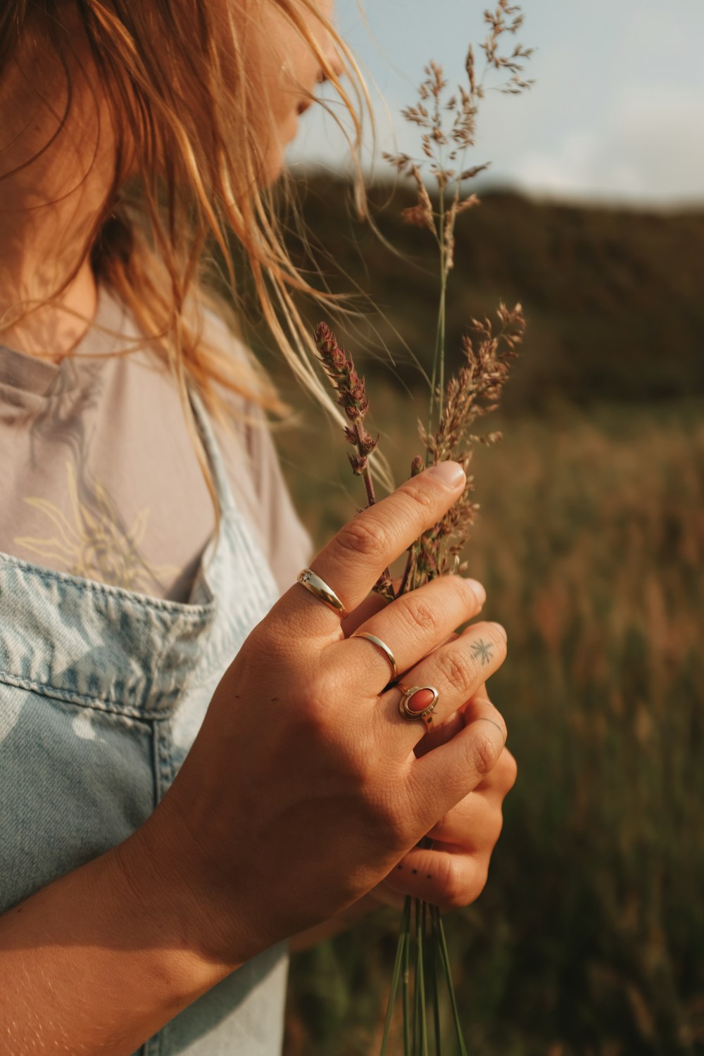 a woman holding a plant in her hands