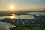 Aerial shot of a coastal luxury hotel at sunset with warm golden light