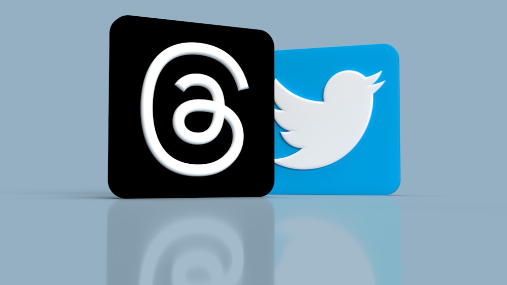 a black and a blue twitter logo