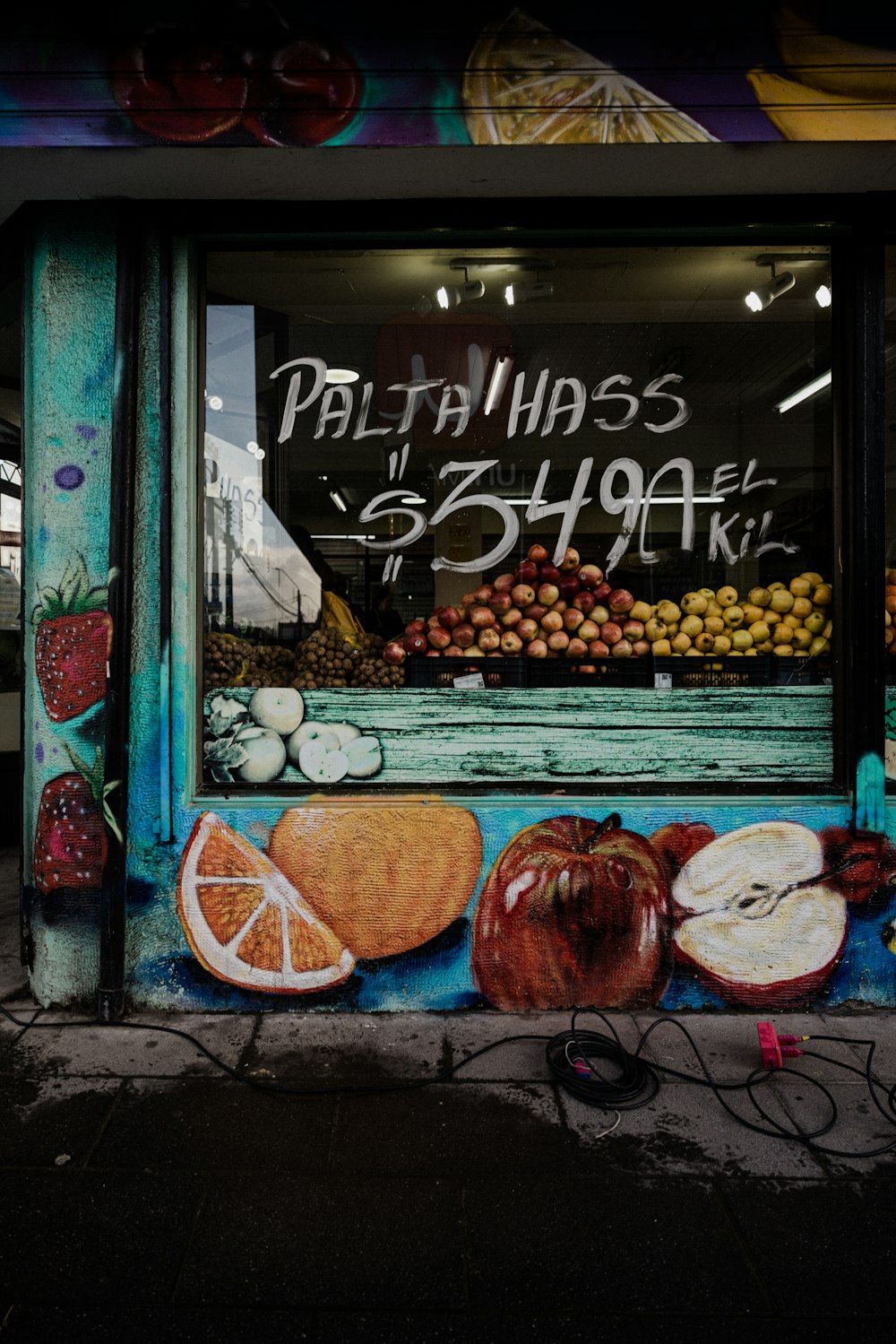 a store front with a painting of fruit and vegetables