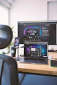 a desk with a laptop and a monitor on it
