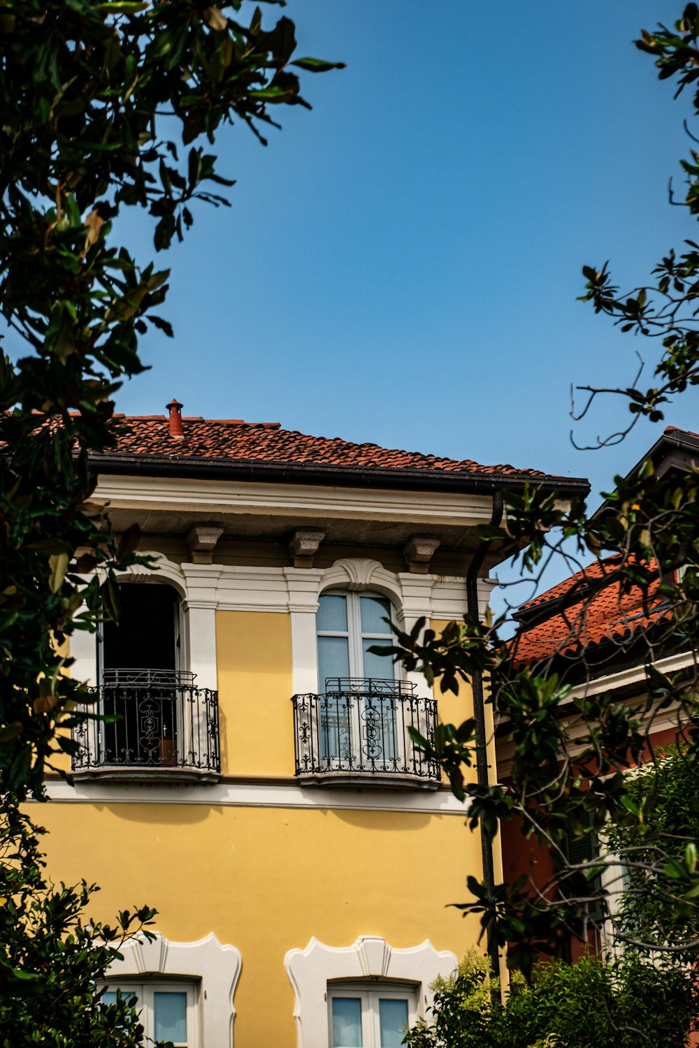 a yellow building with a balcony and balconies