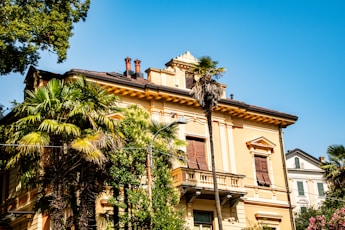a large building with palm trees in front of it