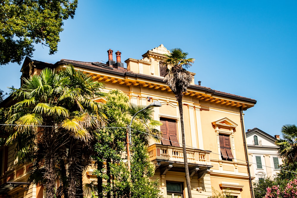 a large building with palm trees in front of it