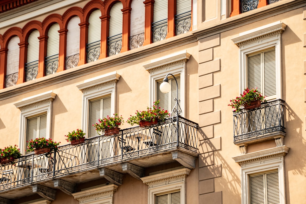 a building with a balcony and flower boxes on the balconies