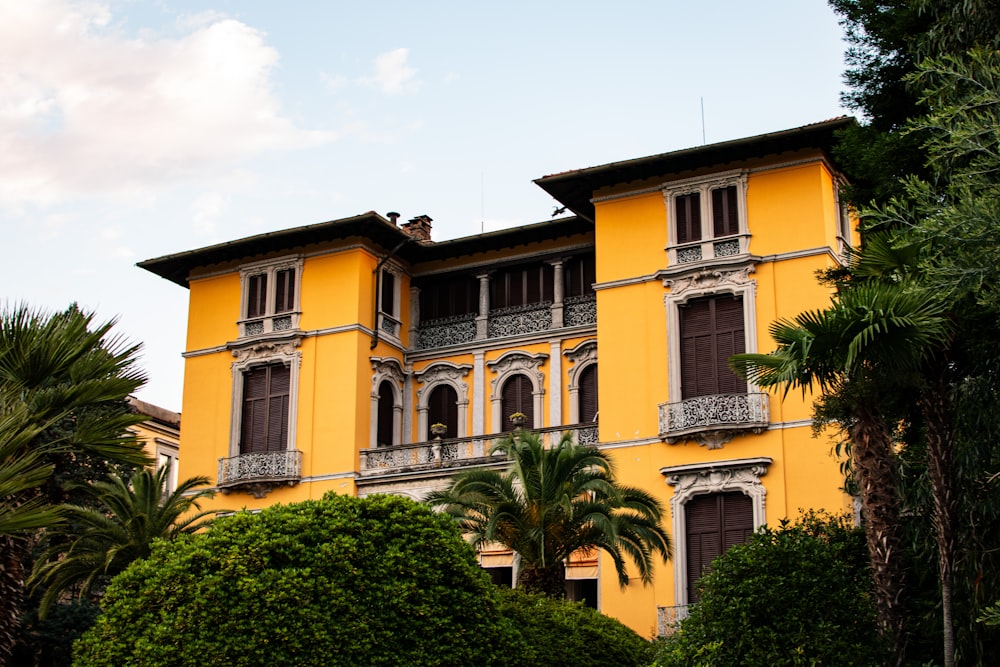 a large yellow building with many windows and balconies