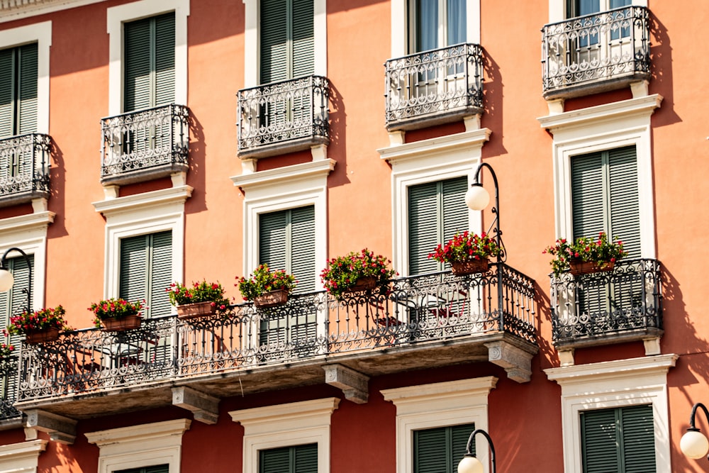 a building with a bunch of flowers on the balconies