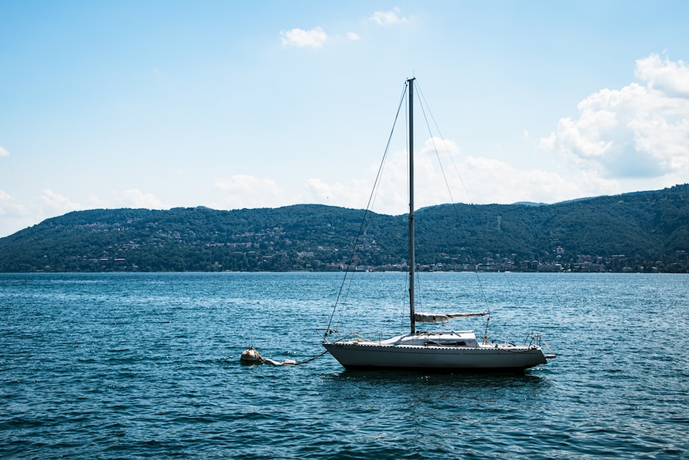 a sailboat floating in the middle of a body of water