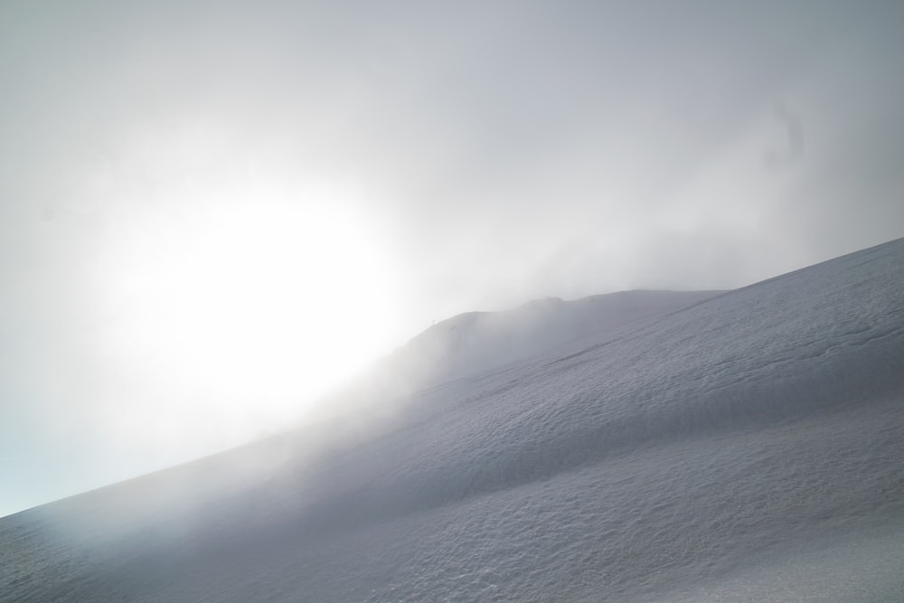 a person riding skis down a snow covered slope