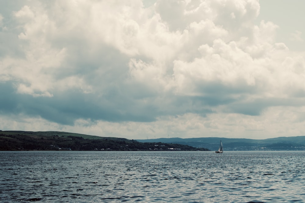 a large body of water under a cloudy sky