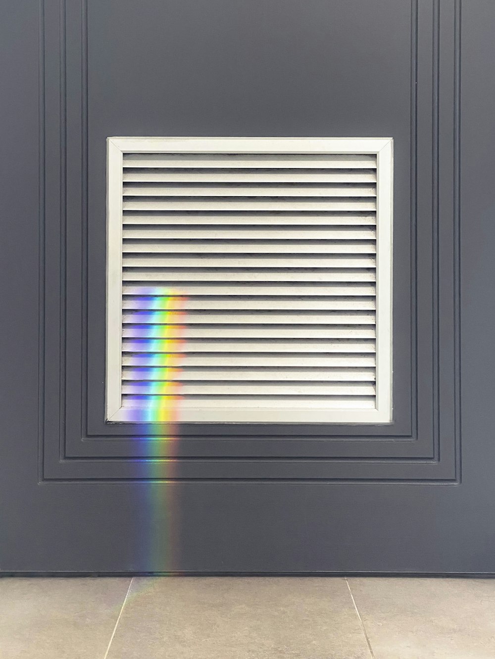 a rainbow of light shining through a window