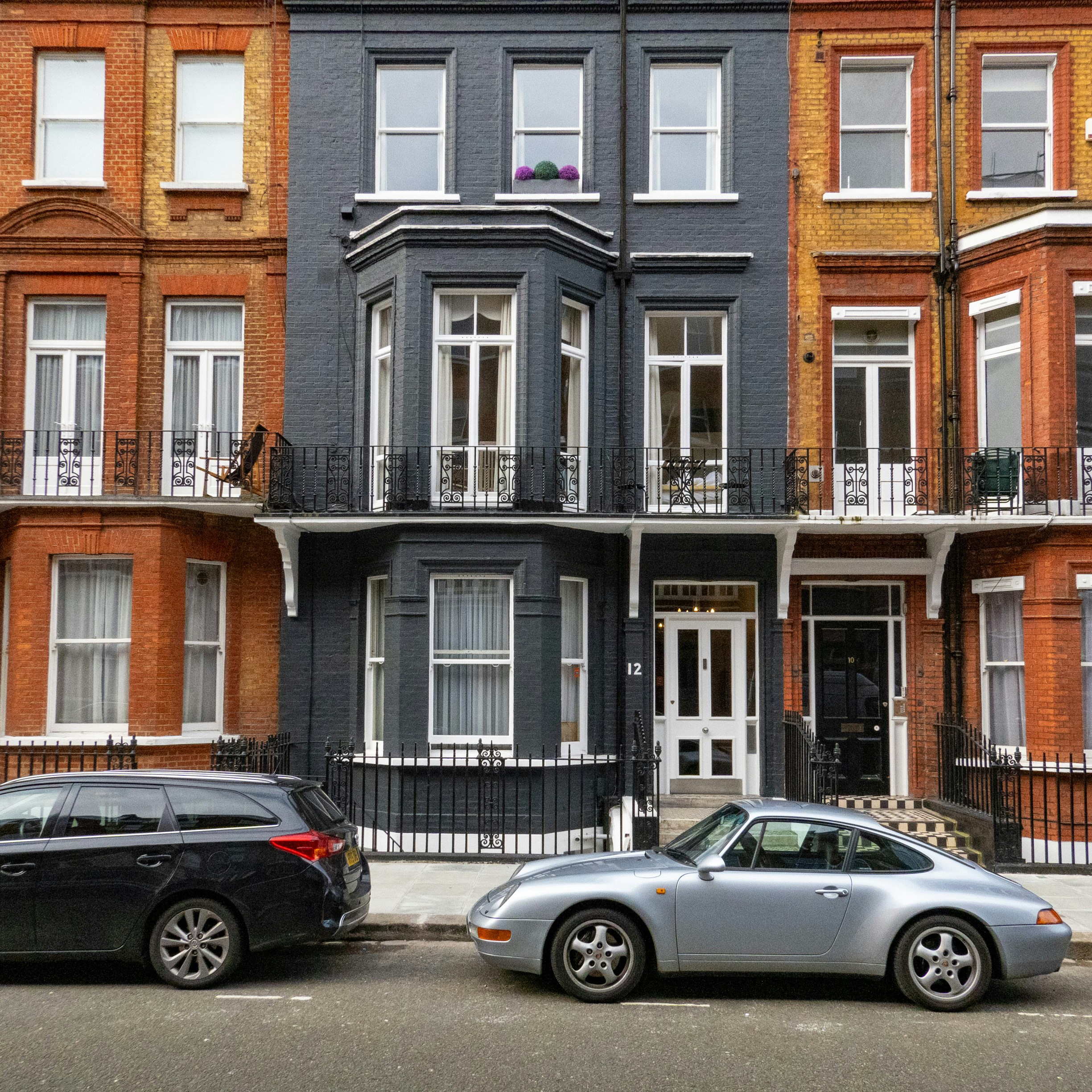 a couple of cars parked in front of a building