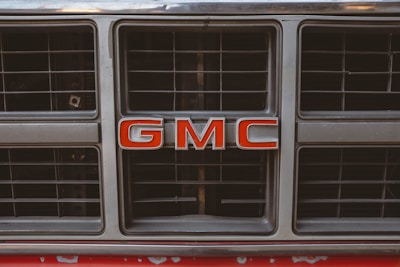 Close-up of a winner holding the keys to their shiny new GMC truck, excitement in their eyes.