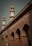 A brick building with ornate architectural details featuring pointed arches and two taller minarets. The structure has a sign labeled 'K.A. Nizami Centre for Quranic Studies' indicating its academic or religious significance.