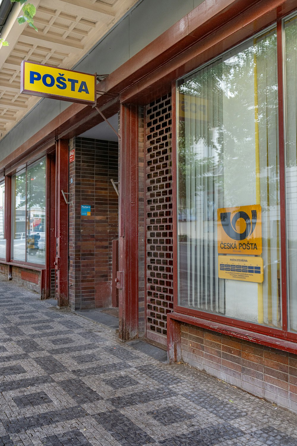 a post office with a post office sign above the door