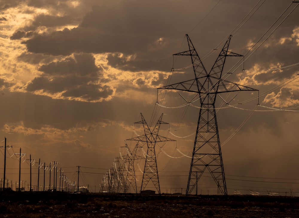 a line of power lines against a cloudy sky