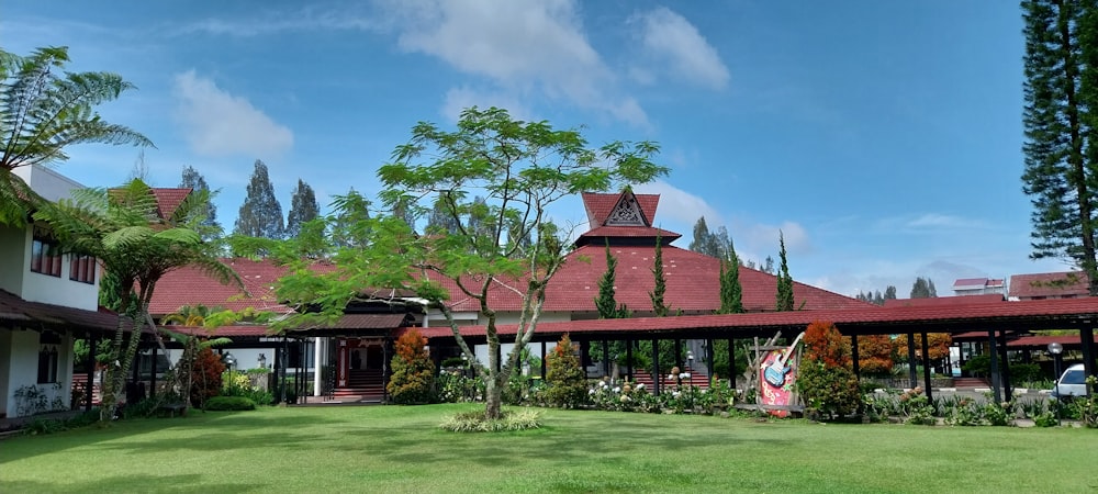 a house with a red roof and a green lawn