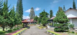 Happy families enjoying the landscaped gardens within a Sai Skyline Infra residential project.
