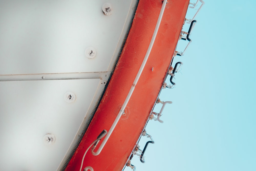 a close up of a red and white boat