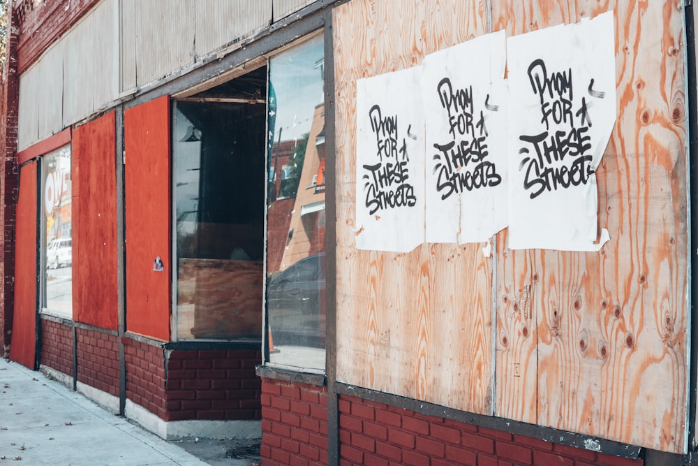 a boarded up building with graffiti on it