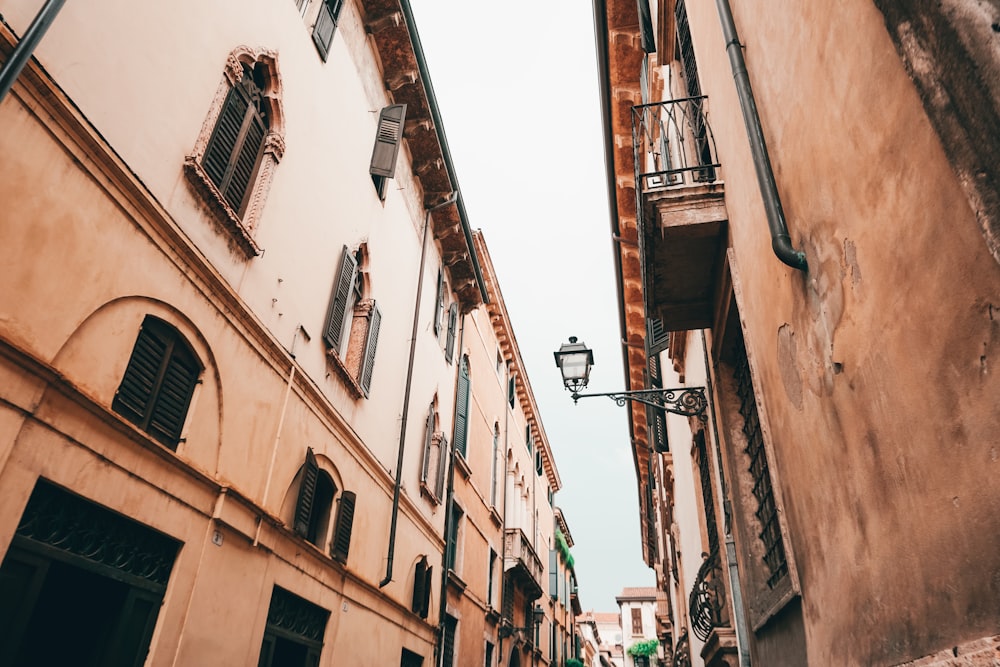 a narrow street with a lamp post and buildings