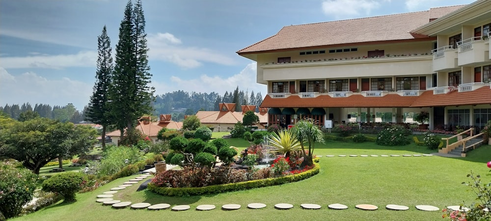 a large building with a garden in front of it