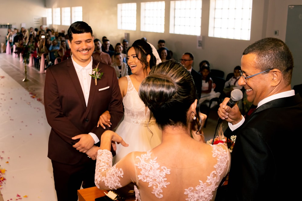 a man in a suit and tie standing next to a woman in a wedding dress