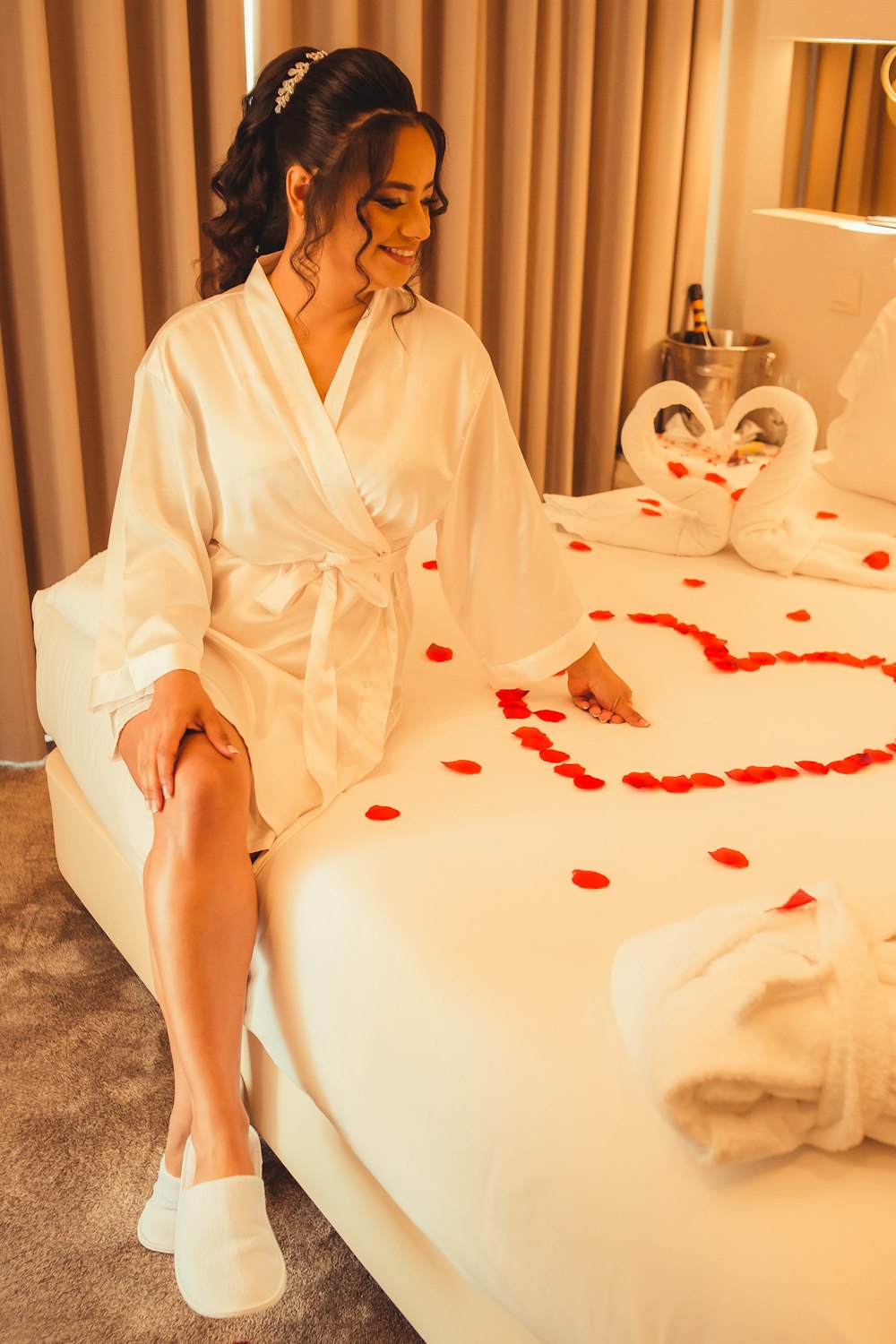 a woman in a robe sitting on a bed