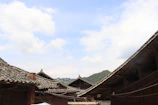 Traditional Sasak village houses with thatched roofs under a bright blue sky