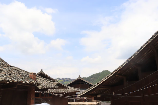 Traditional Sasak village houses with thatched roofs under a bright blue sky