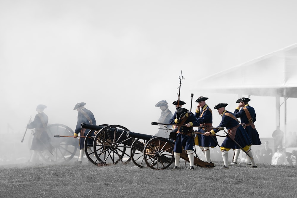 a group of men standing next to each other on top of a field