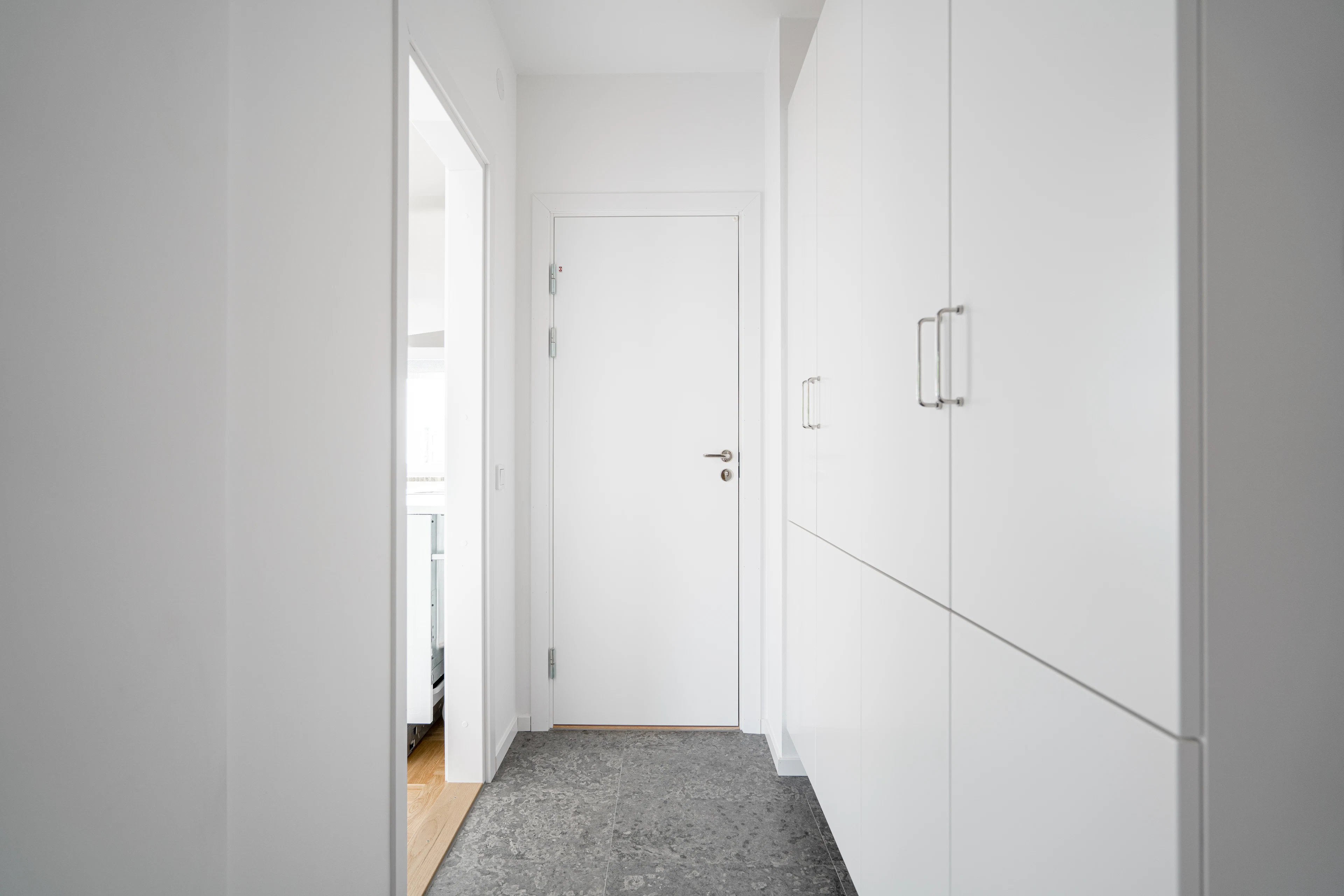 Floor-to-ceiling white hallway cabinetry
