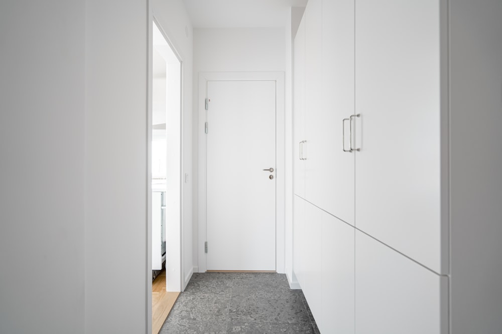 a long hallway with white walls and doors