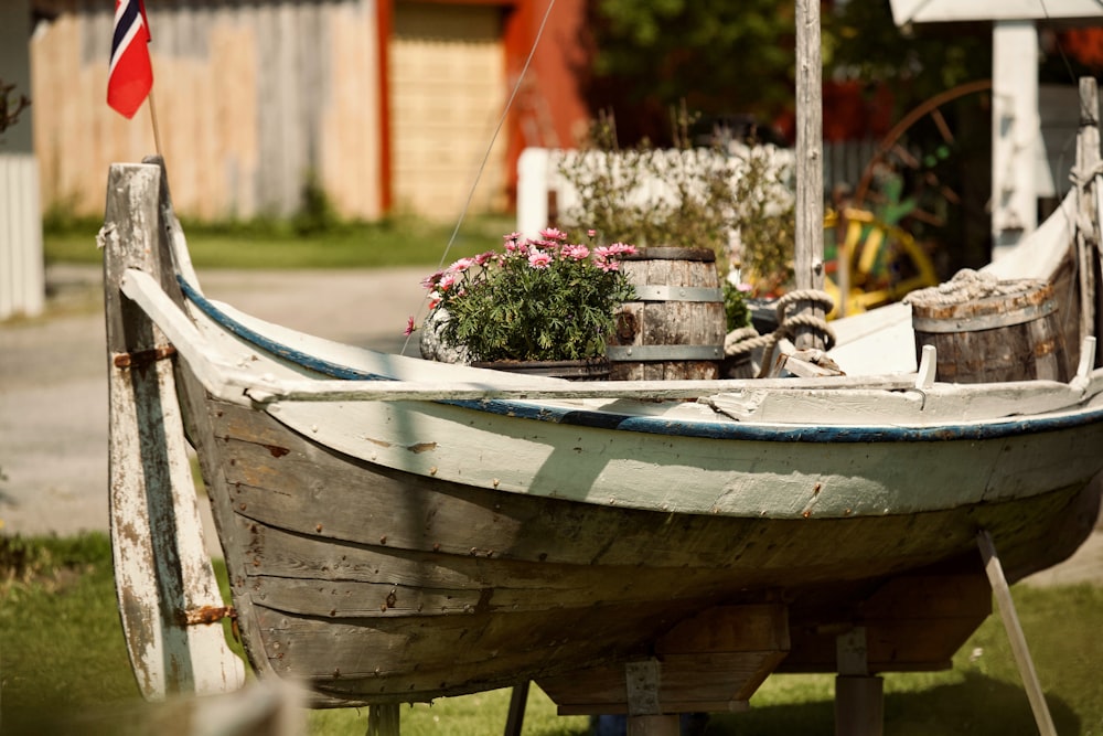a boat with a flower pot on the front of it
