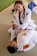 A happy student practicing jiu-jitsu on the mat.