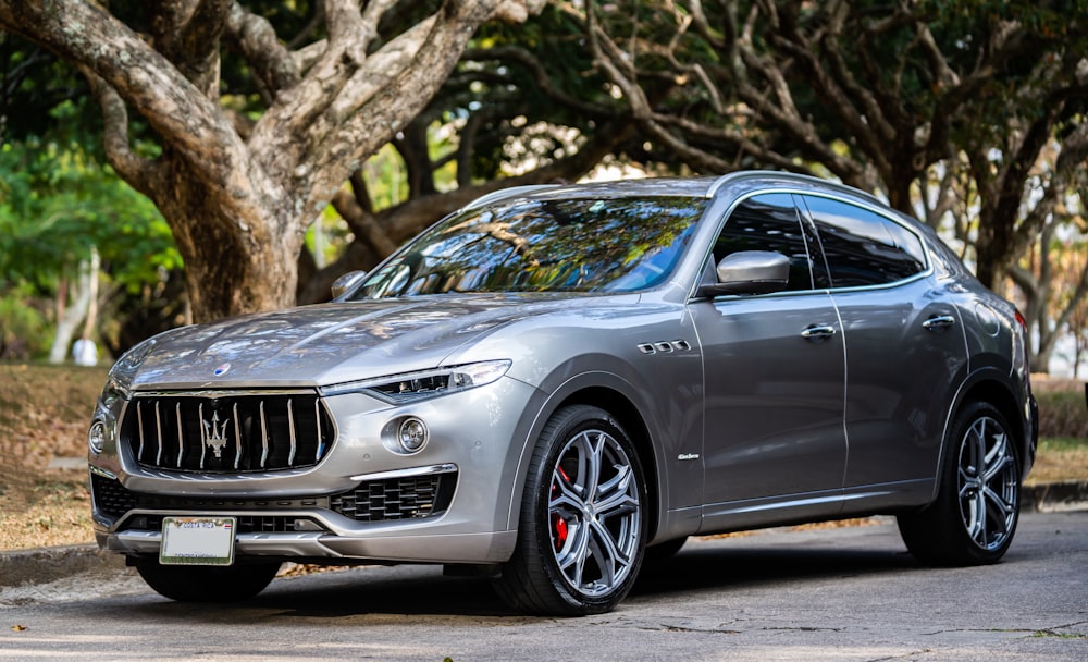 a silver masera parked on the side of the road