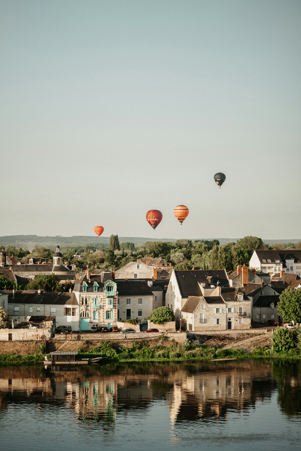 a group of hot air balloons flying over a city