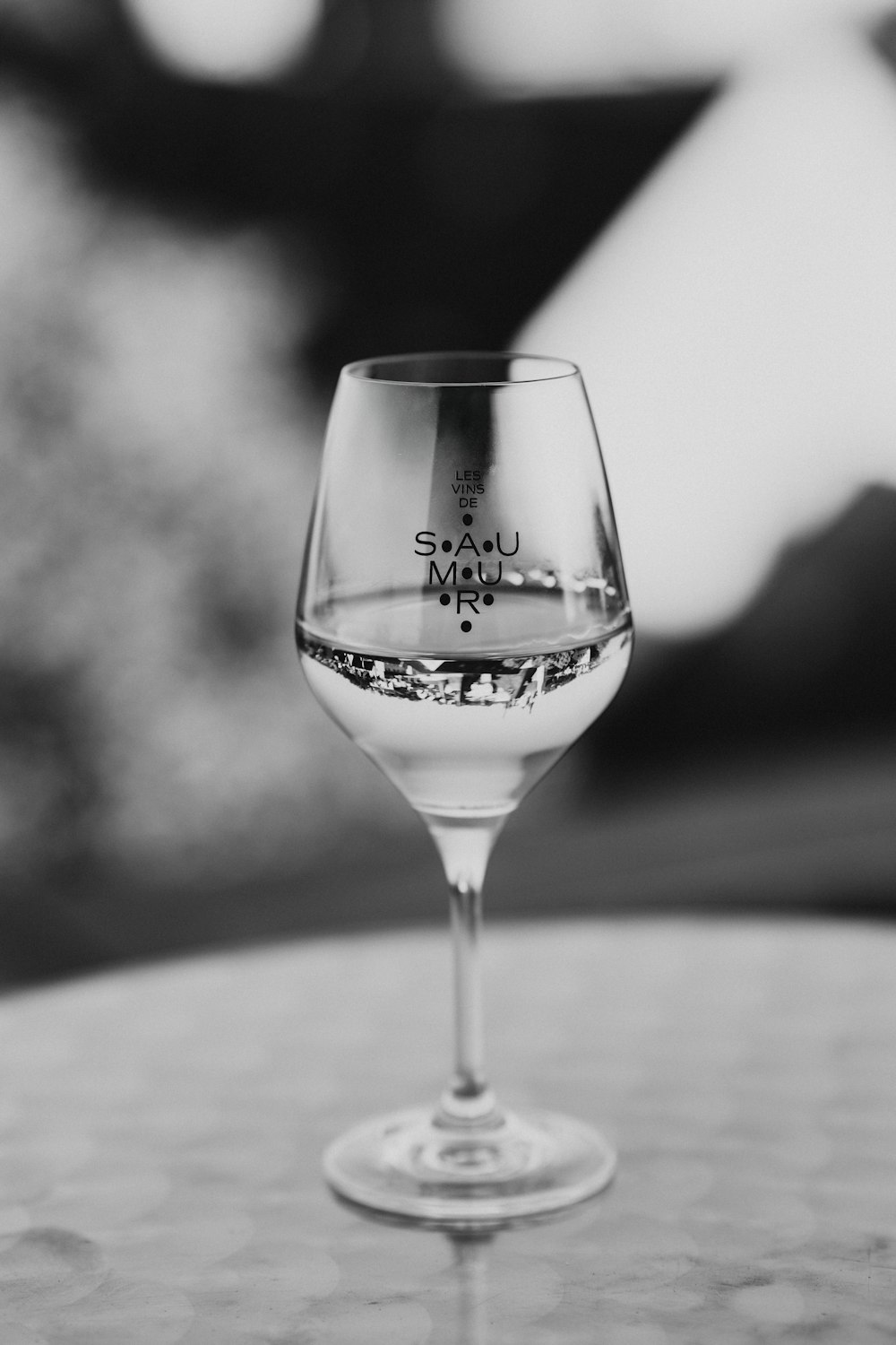 a wine glass sitting on top of a table