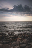 A quiet moment of reflection by the ocean under a moody, overcast sky