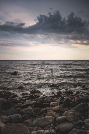 A quiet moment of reflection by the ocean under a moody, overcast sky