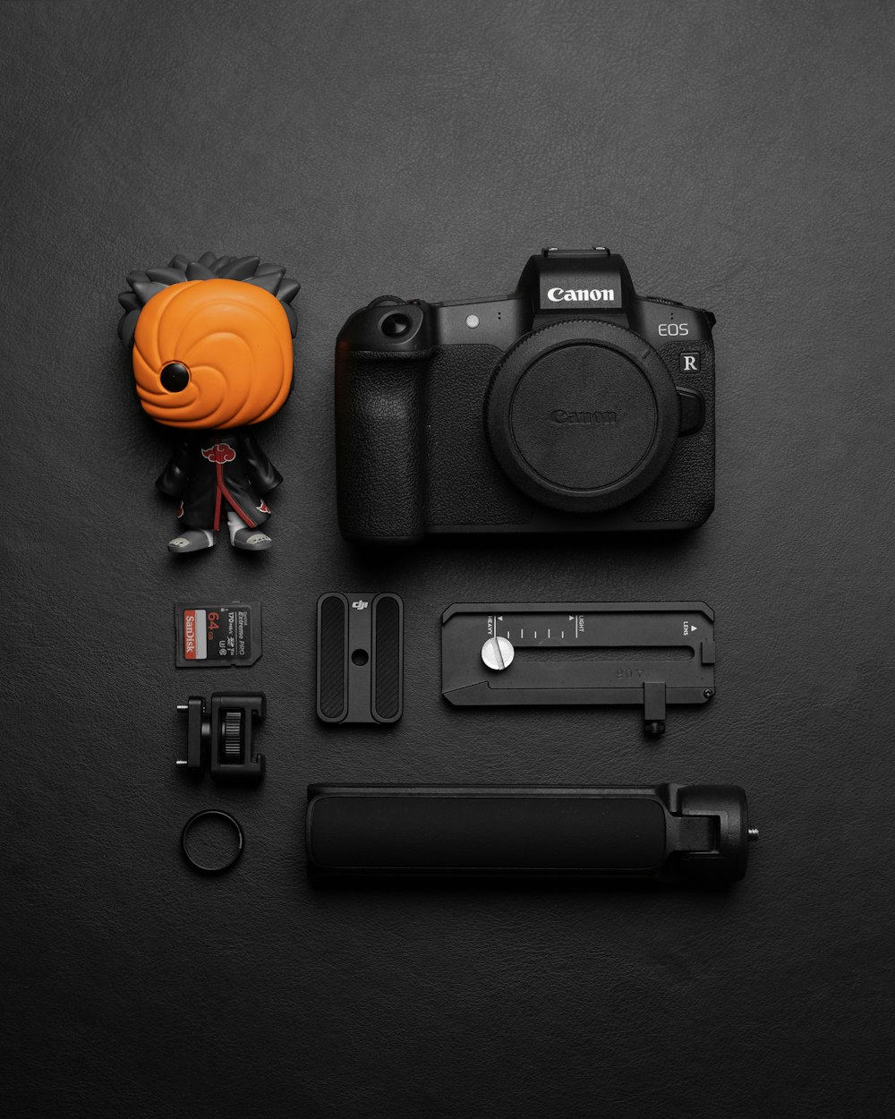 a camera with a small orange object next to it