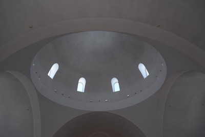 Close-up view of a dome’s structural framework with sunlight filtering through.