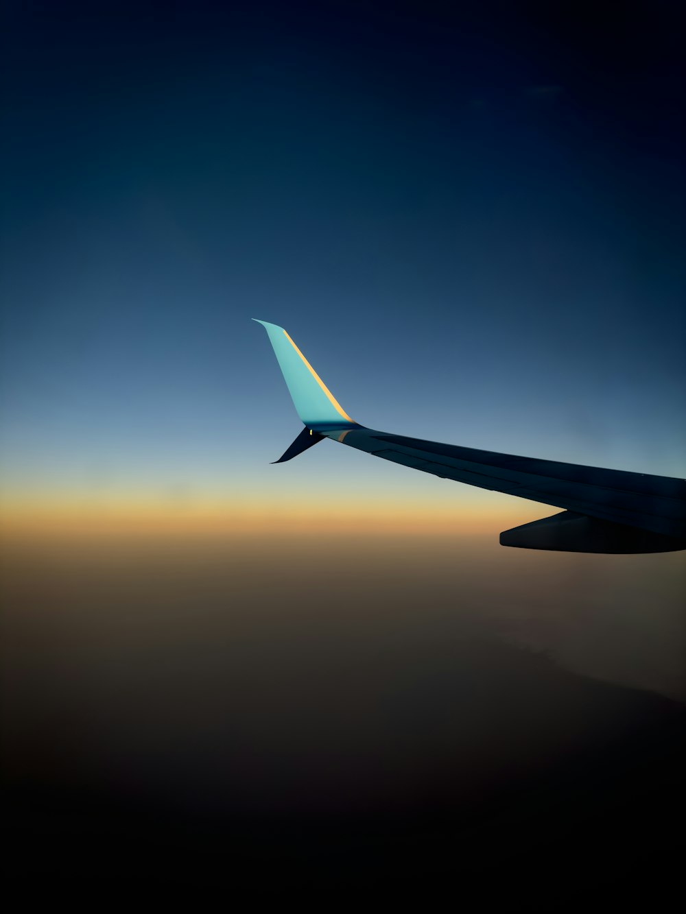 a view of the wing of an airplane in the sky