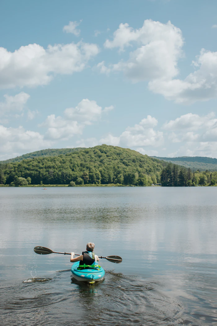 testimonial-01 — Olivia paddling on a calm lake, an outdoor adventure moment