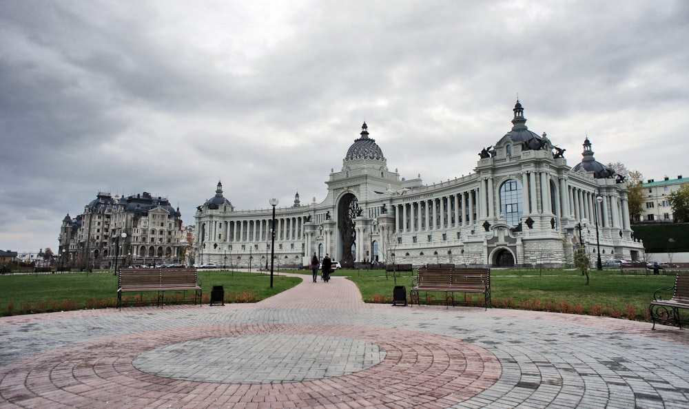 a large white building with a circular walkway in front of it