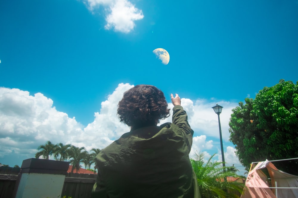 a person flying a kite in a blue sky