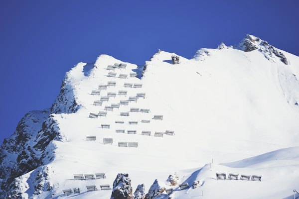 A snow covered mountain with a bunch of windows on it — Tignes, France