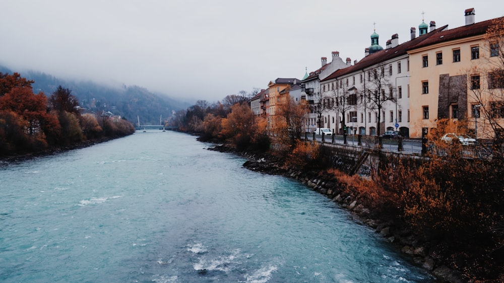 a river running through a city next to tall buildings