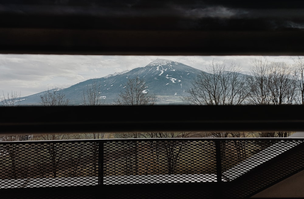 a view of a snow covered mountain from a window