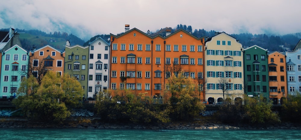 a row of colorful houses next to a body of water